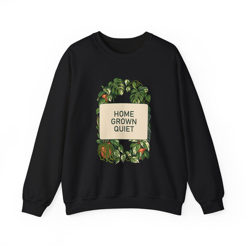 Muted botanical foliage framing the words HOME GROWN QUIET on a crewneck sweatshirt.